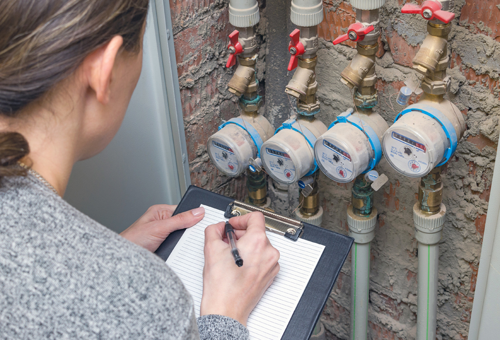 Woman reading the water meter. Household water consumption, conc