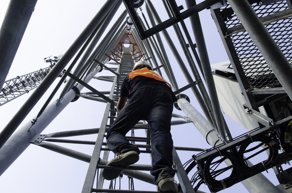 technician working on high telecommunication tower,worker wear P