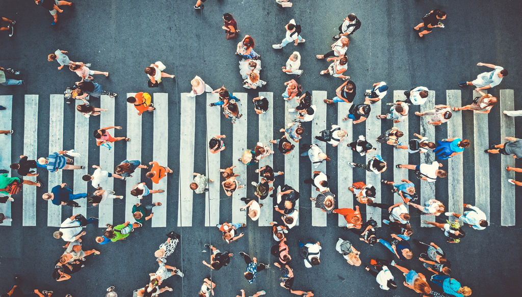 Aerial. People crowd on pedestrian crosswalk. Top view backgroun