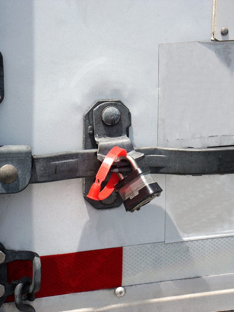 Detail of trailer door with padlock and anti tamper device.