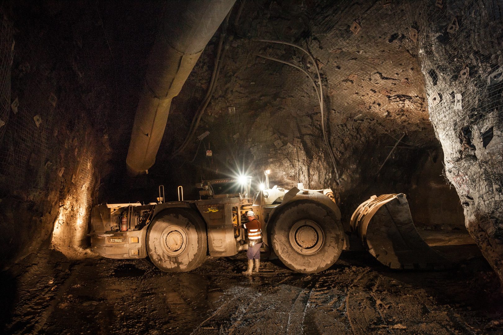 Miner with a large truck known as a ‘bogger’ underground at a copper mine in NSW, Australia