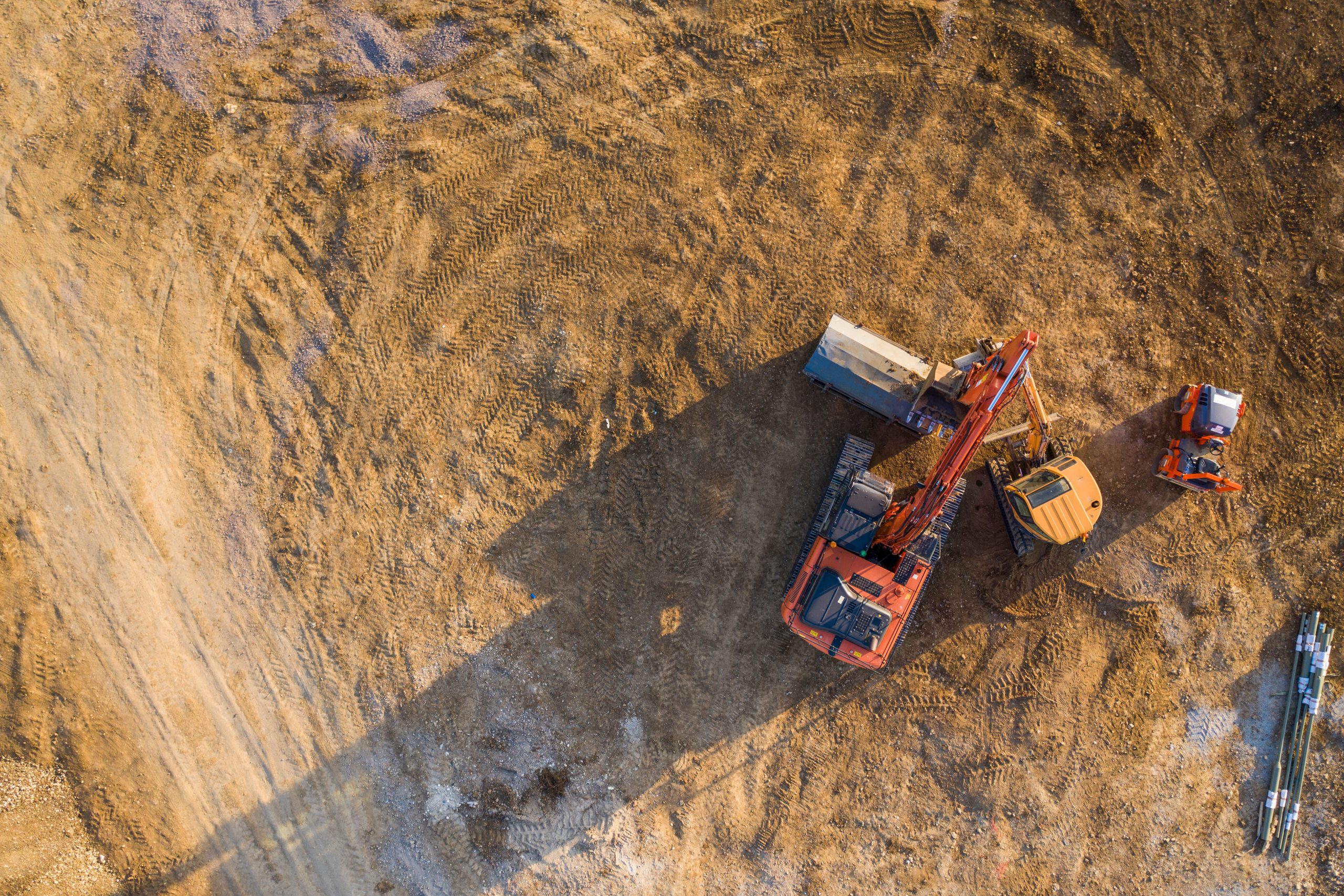 Aerial view over heavy machinery on a building construction site