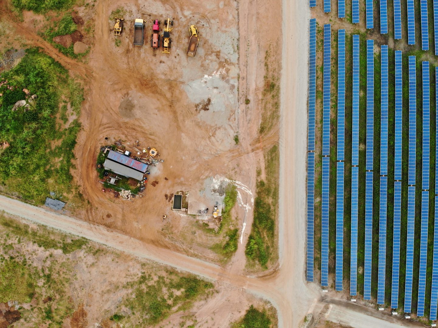 Solar construction site with a boabab tree in Malawi, Africa. It is a 20 mega watt farm under construction. The boabab tree was kept and the solar farm was designed around it.
