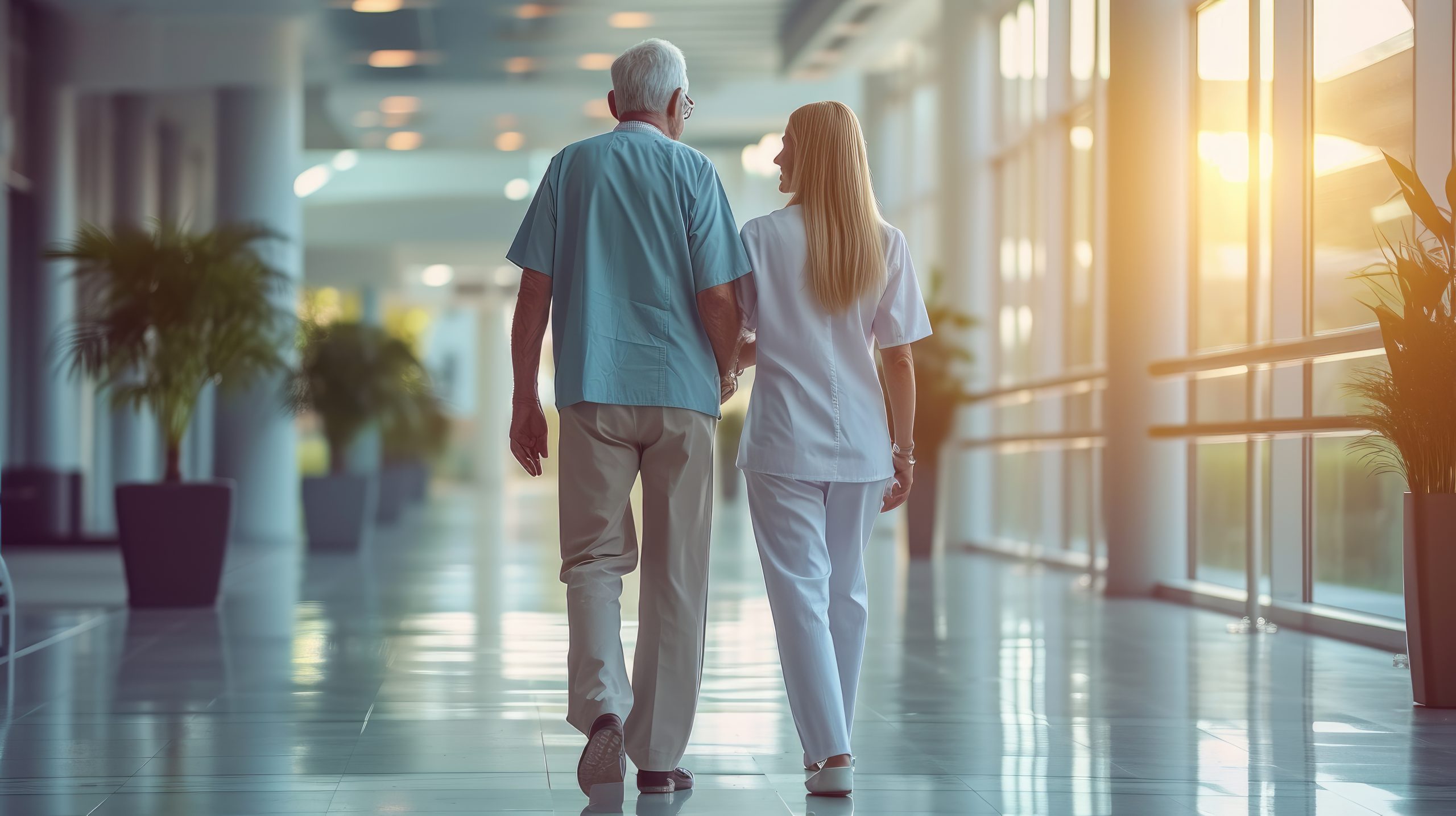 Young nurse helping elderly man walk in the room, elderly man walking with the assistance of a caring nurse down a well-lit hospital hallway, symbolizing health care, support, and companionship